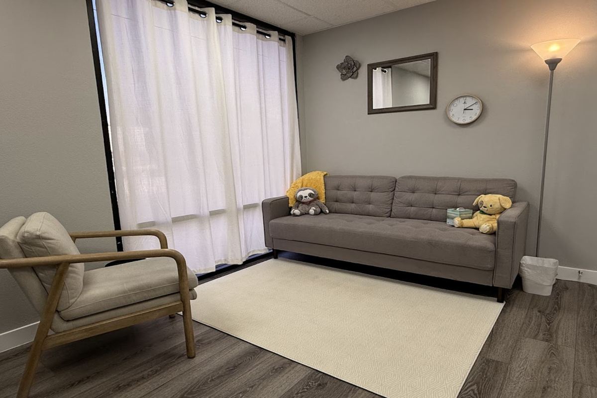 A Brighter Future therapy room with a couch, warm lamp and window light