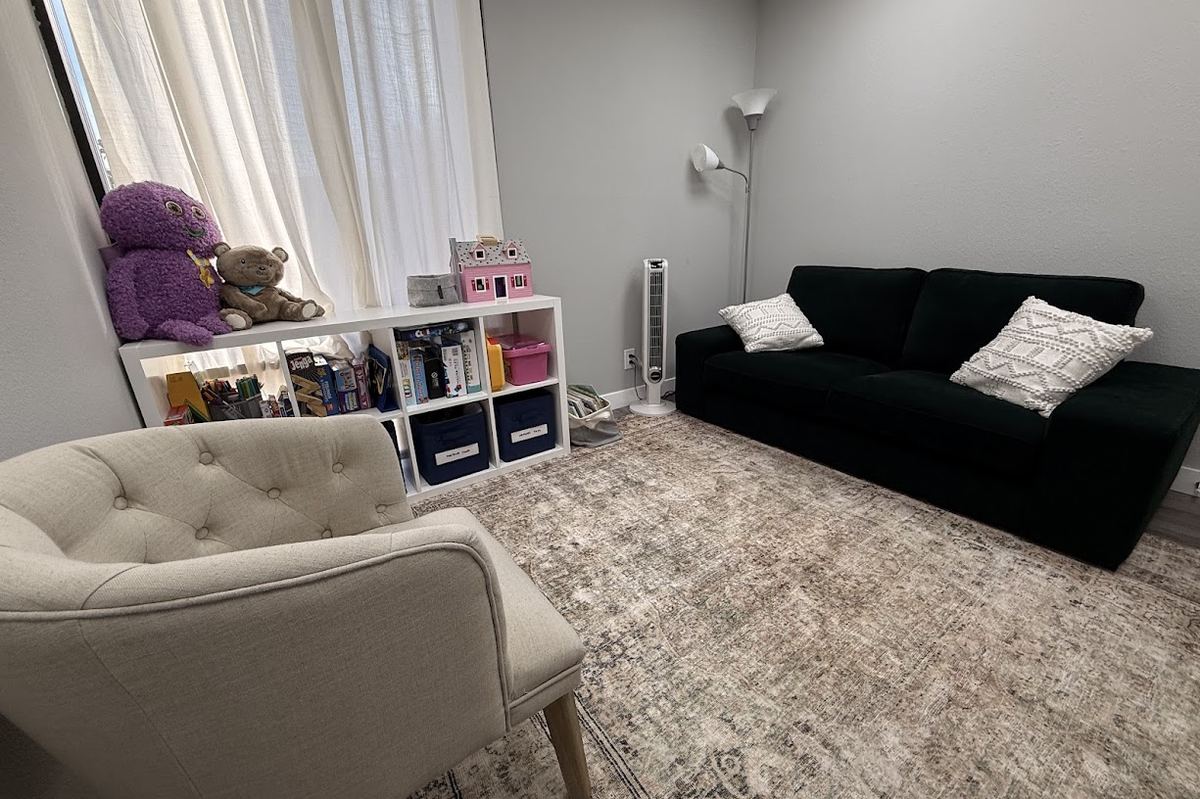A Brighter Future therapy room set up for children, with toys, books and comfortable seating