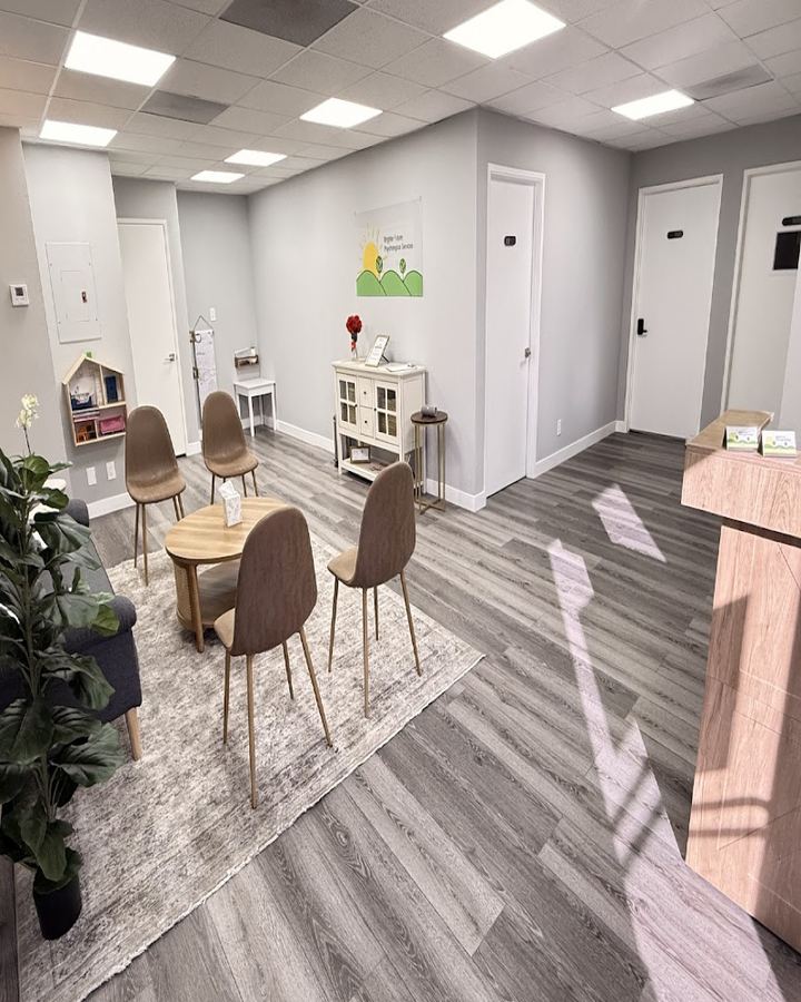The Brighter Future waiting room in Glendora, with soft chairs, a rug and a play corner